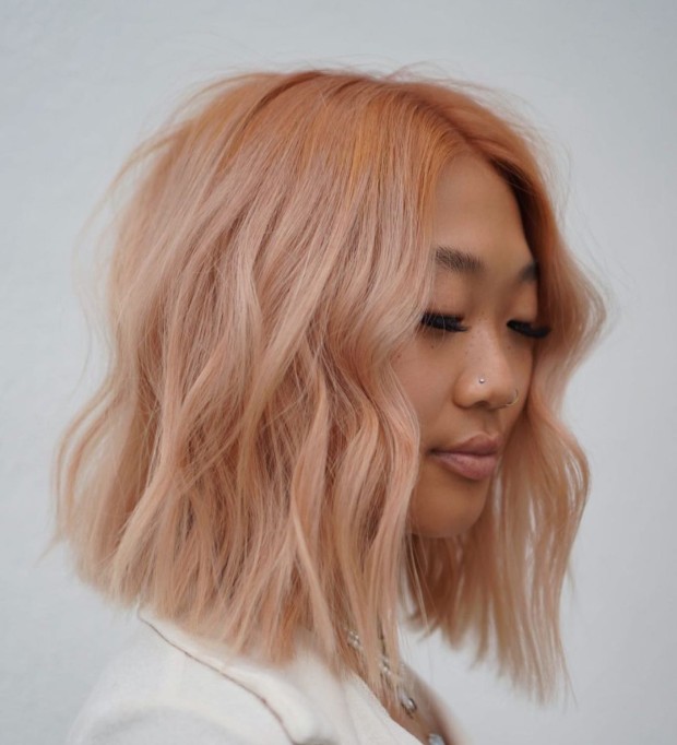 Peach hair color on lob haircut with waves